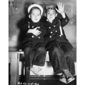   .) evacuation   Two Japanese boys, one with strip Remember Pearl H