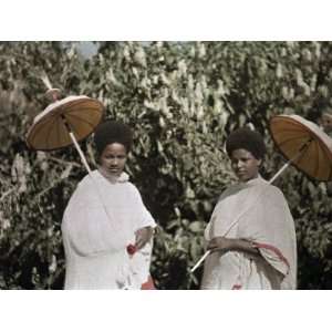  Two Amharic Women Pose Holding Umbrellas to Shade 