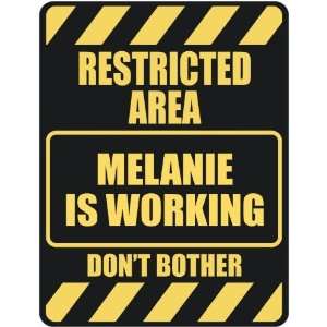   RESTRICTED AREA MELANIE IS WORKING  PARKING SIGN