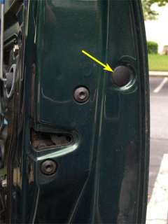 Remove the small plastic tab on the rear edge of the door with a 